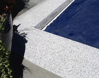 white granite drop face pool coping