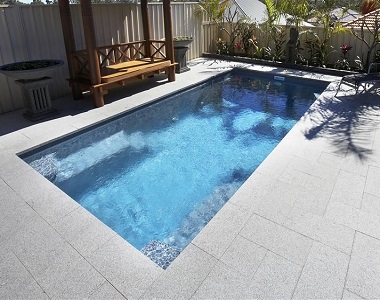 white granite pavers around a pool 
