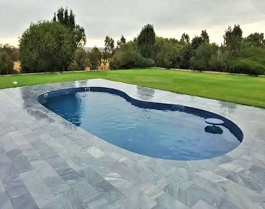 grey limestone pavers around a pool