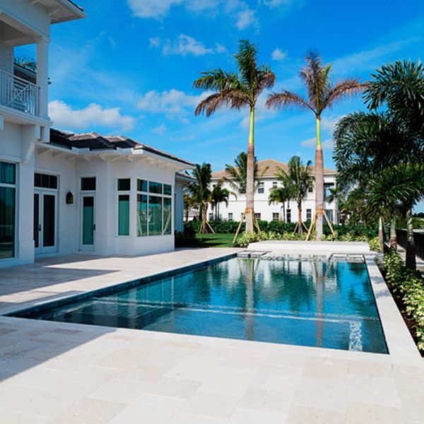 white travertine tiles around pool , natural stone pavers